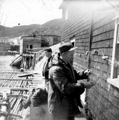 609: Michael Carroll mending nets. Mike's son John laying down behind him. (1960) [courtesy of Catherine (Watson) Carroll]  - Michael son of John Carroll &amp;amp; Elizabeth Reddy